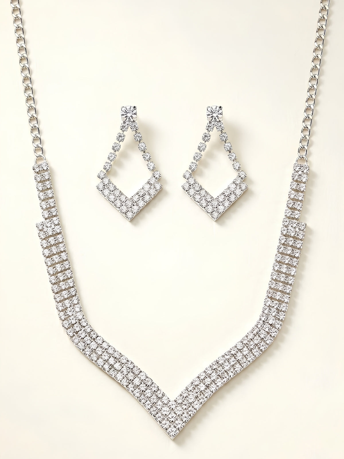 Elegant Crystal Studded Necklace Set styled with silver-plated V-shaped pendant