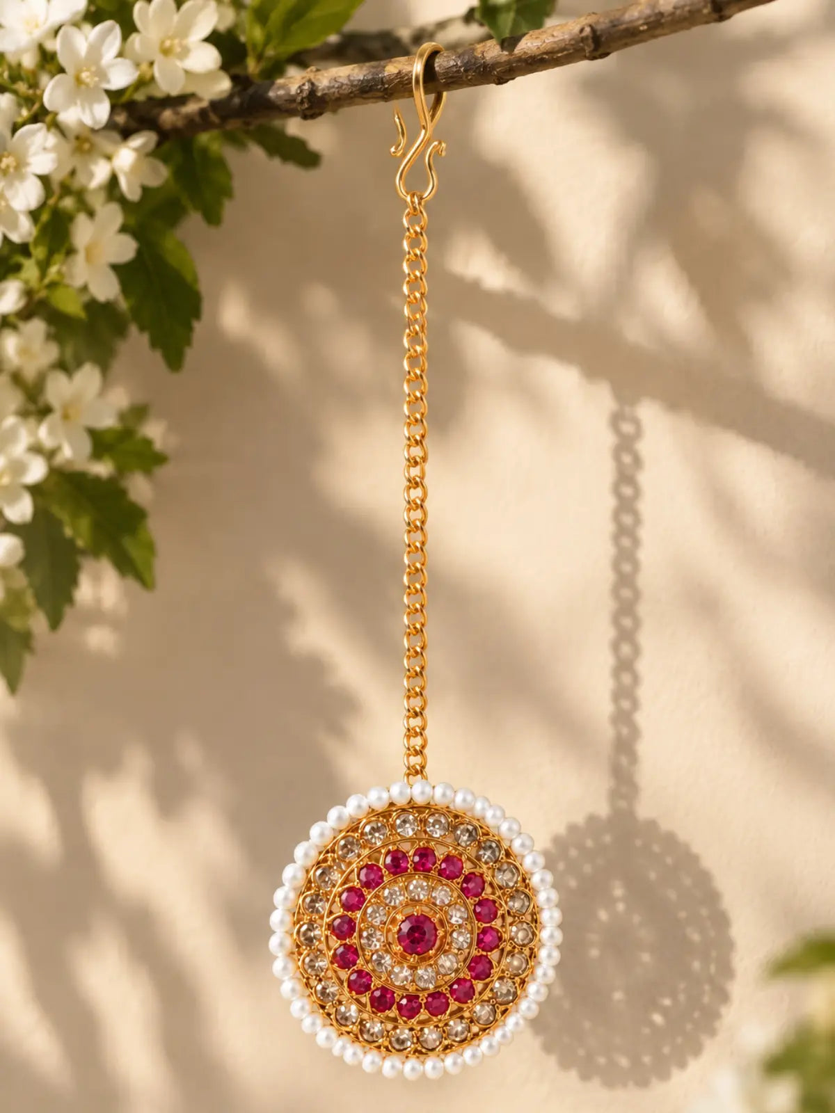 Round gold-tone maang tika with dual-tone stone embellishments