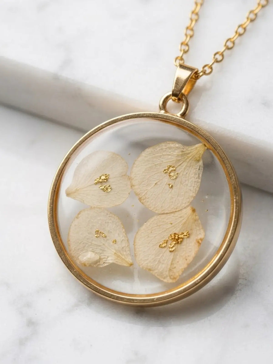 White floral pendant with gold chain